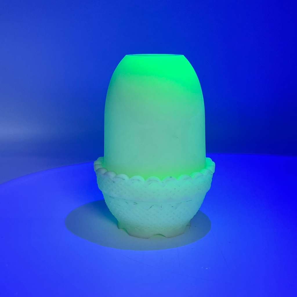 Vintage fairy lamp glowing green under UV light