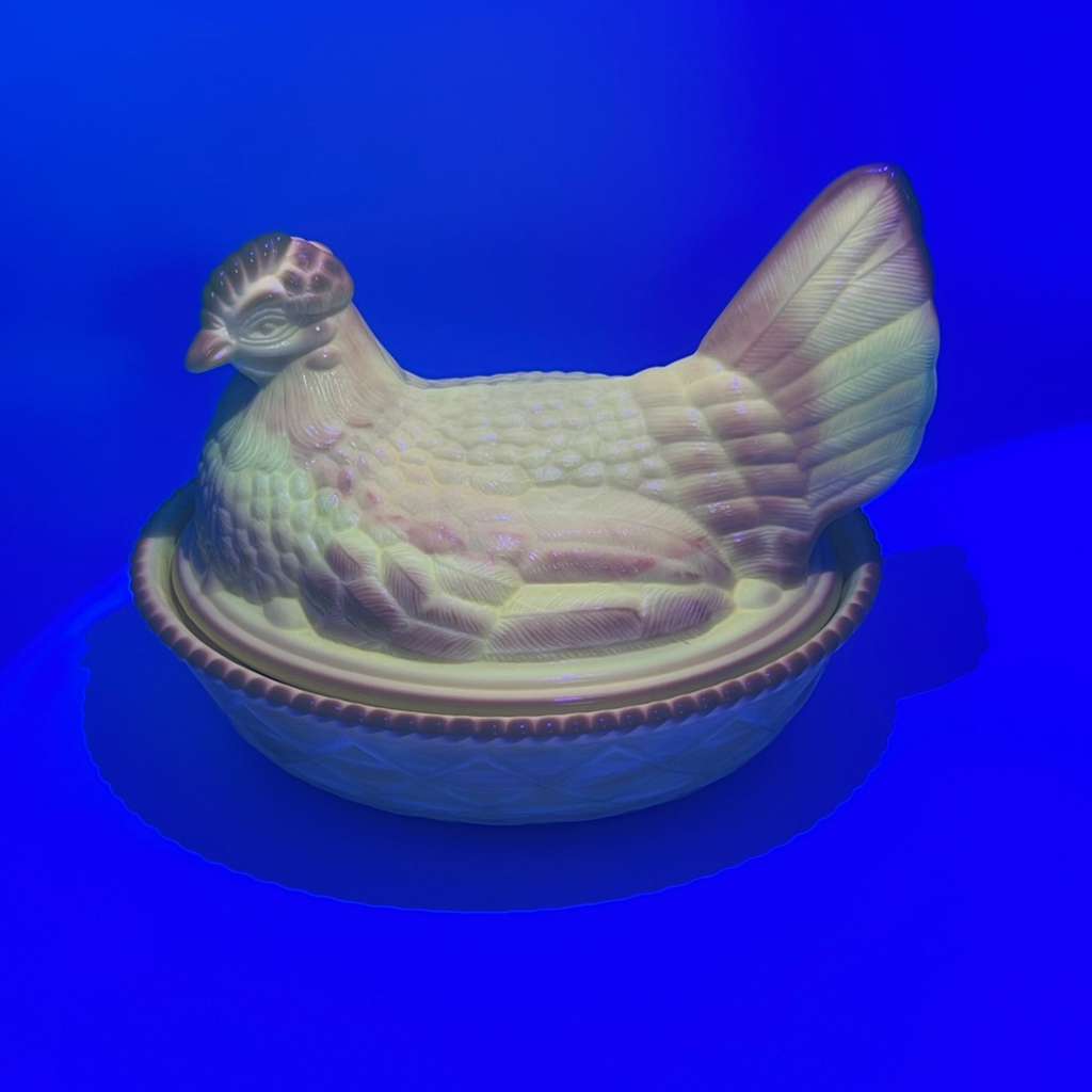 Vintage hen dish glowing under UV light